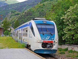 Treno panoramico che attraversa un paesaggio mozzafiato in Italia, tra colline e vigneti.