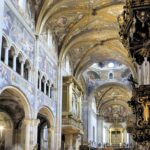 Vista di una pittoresca piazza di una città d'arte minore nel centro Italia, con architettura storica e gente locale.