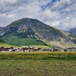 Panorama di un villaggio alpino svizzero, circondato da montagne e natura incontaminata.